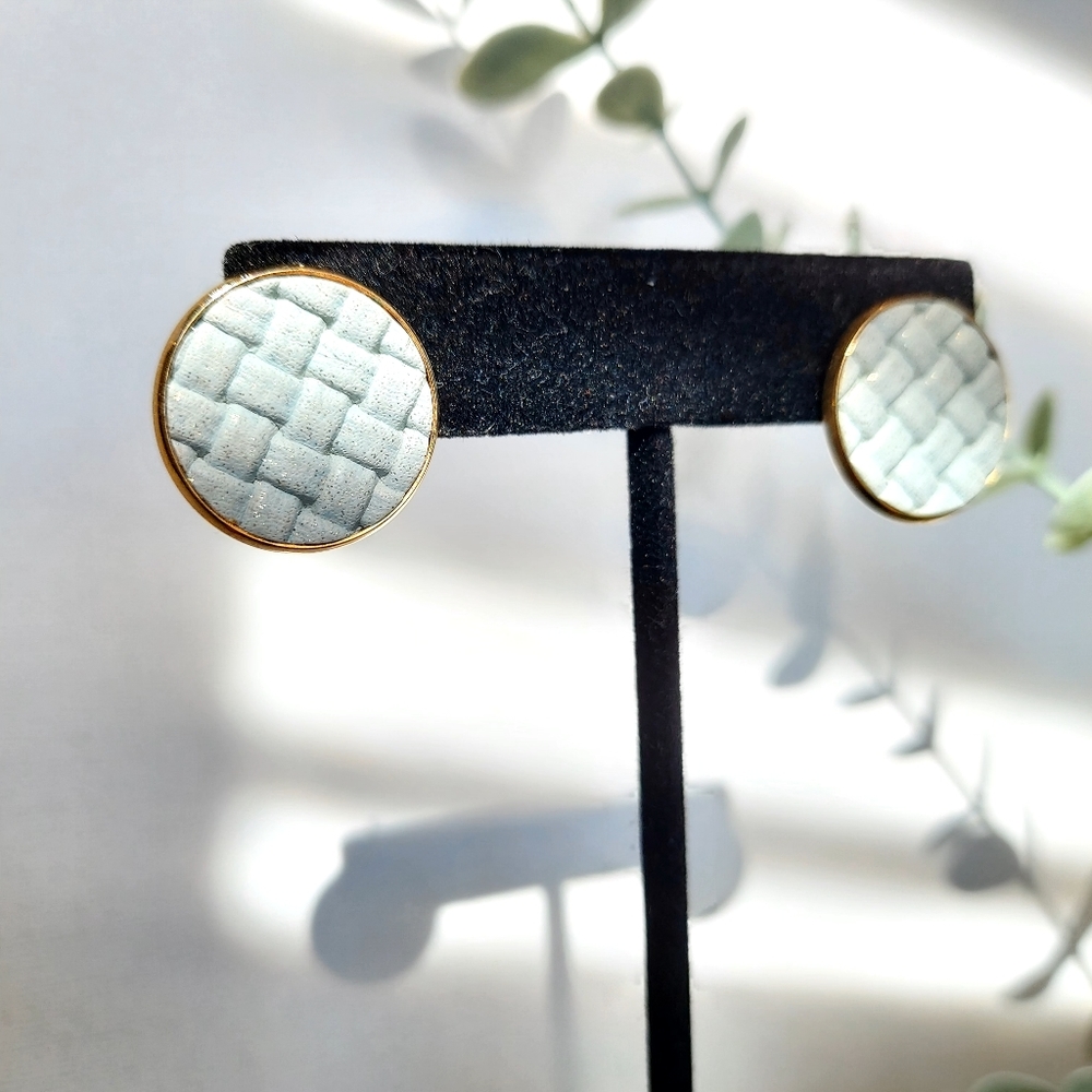 Soft light blue fabric in metal earrings.